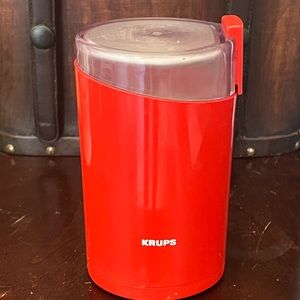 Red Krups 203 coffee grinder 7.75" high 4" oval 2 piece form.